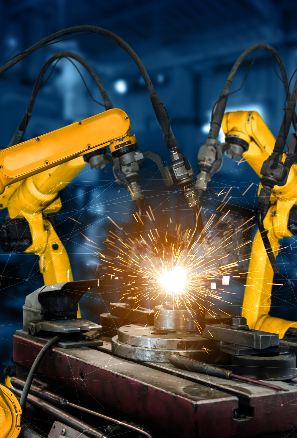To gule industrielle robot-armer som utfører sveising av metall.